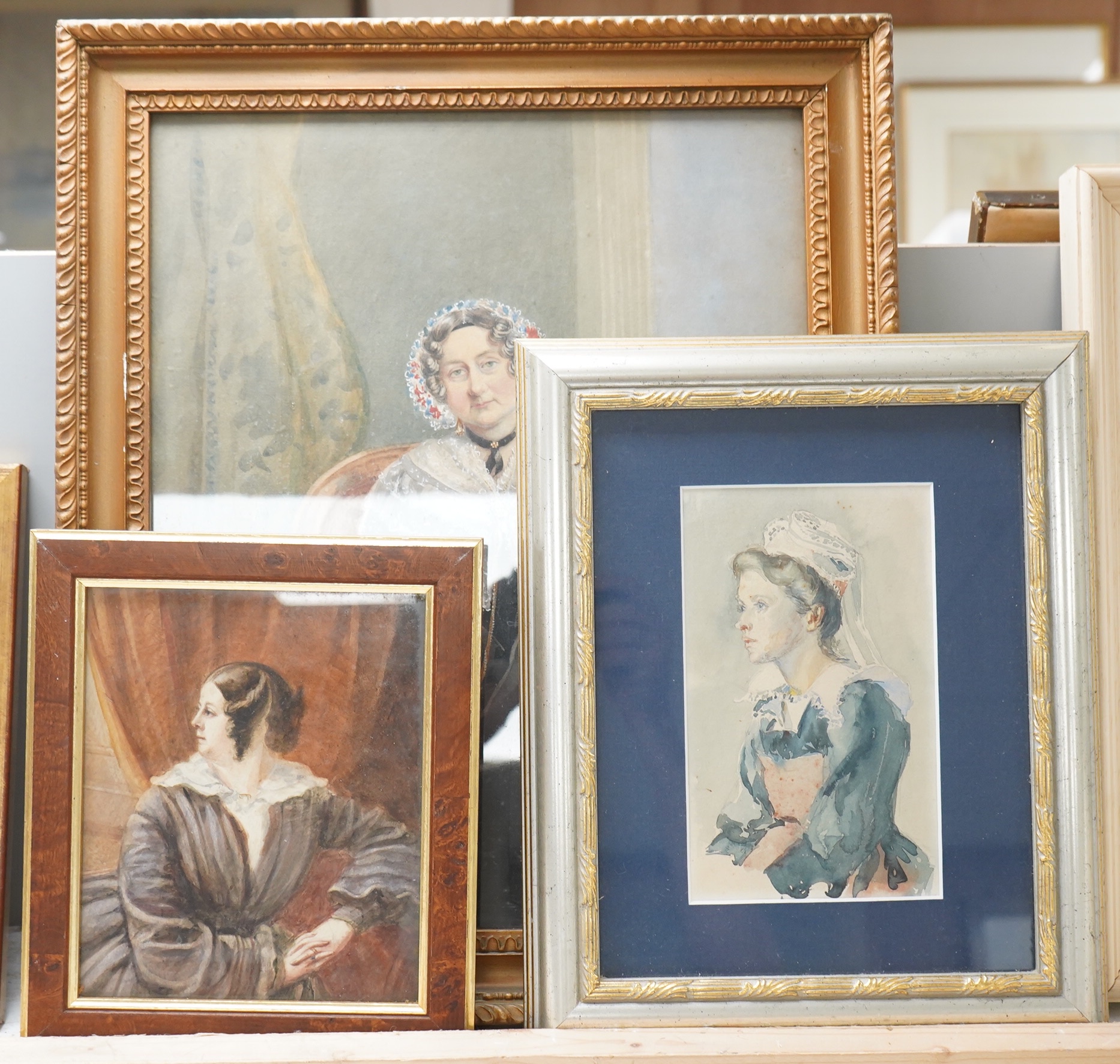Mid Victorian School, Portrait of a seated lady in an interior, unsigned, watercolour, together with two other watercolours, portraits of women, largest 36 x 29cm